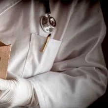 Medical professional holding book titled, "Management of Opioid"