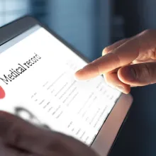 Medical professional holding iPad with medical records