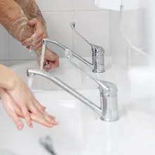 Two medical professionals washing hands at the sink