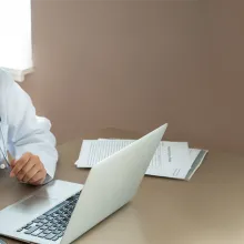 Medical professional sitting at desk on a telehealth visit