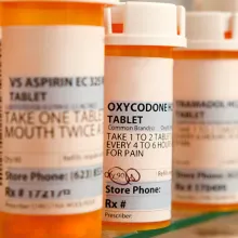 Set of pill bottles on a shelf