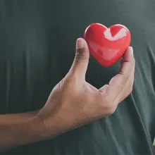 Hand holding red heart