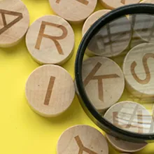 English alphabet letter and magnifying glass on yellow background