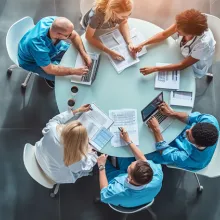 birds eye view of a table with a variety of clinicians around it