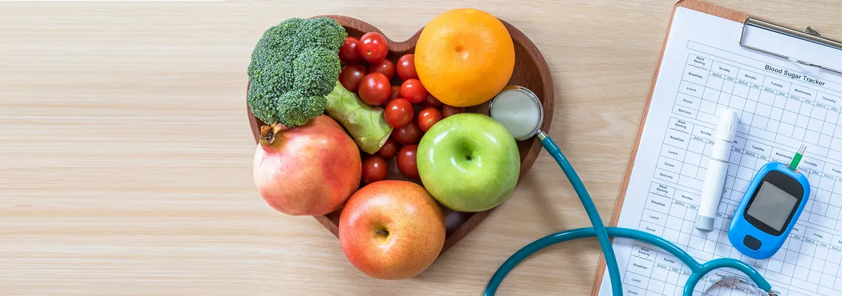 diabetes monitor next to a heart-shaped fruit basket