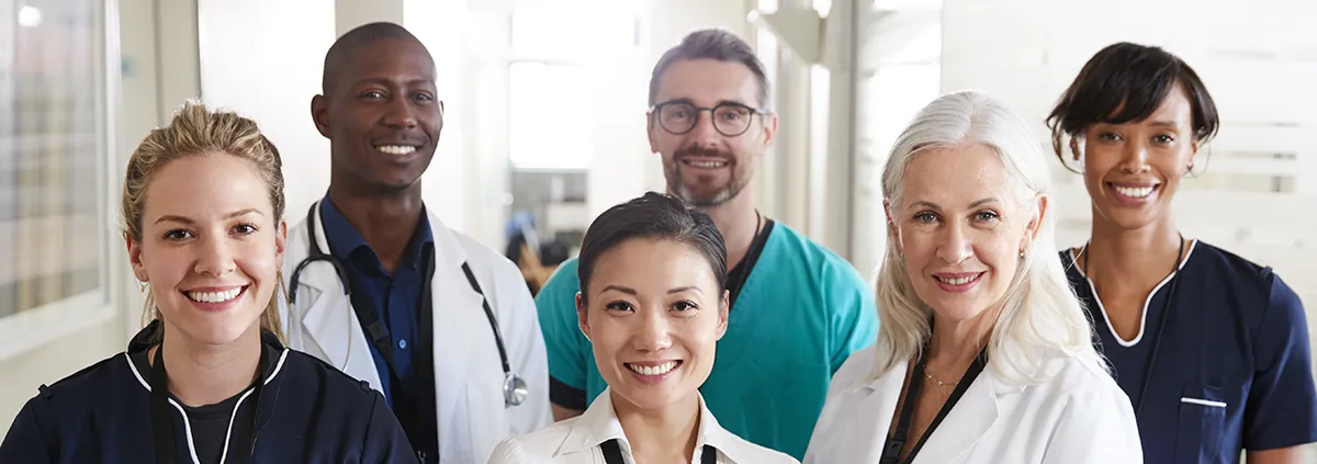 Portrait of medical team standing in hospital corridor