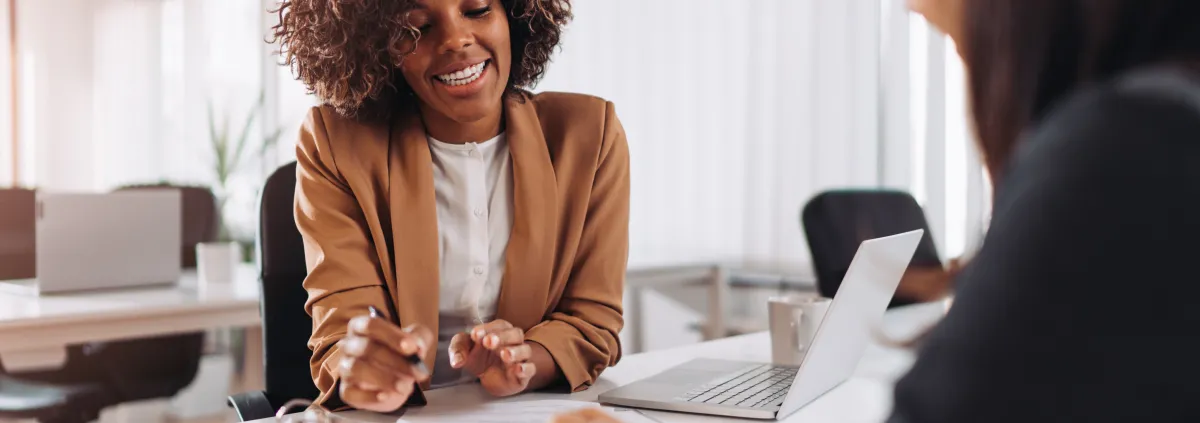 Image of African-American female consultant speaking with a client 