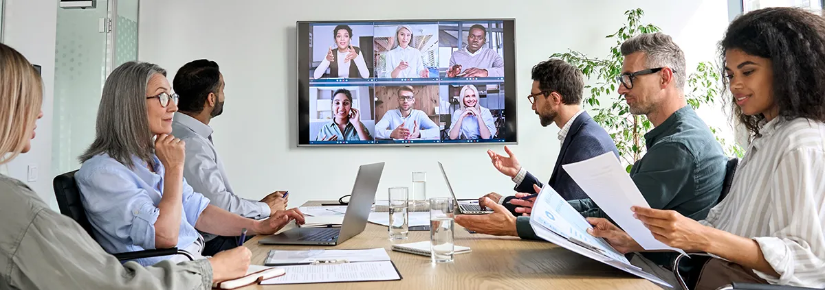 Group of professionals in a conference room doing a virtual meeting