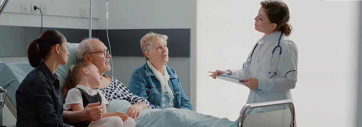 Doctor talking to patient and their family in patients room