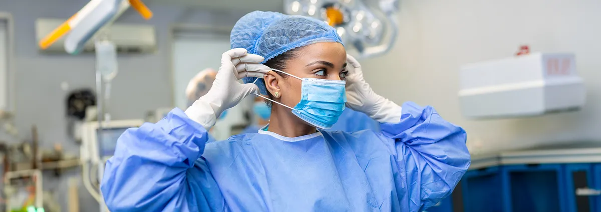 Clinician putting on face mask