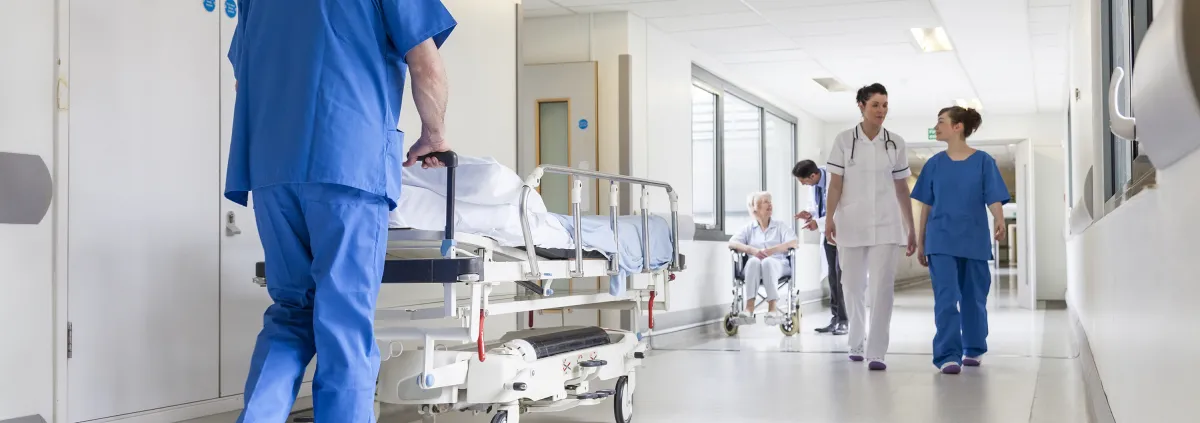 Doctors Hospital Corridor Nurse Pushing Gurney Stretcher Bed