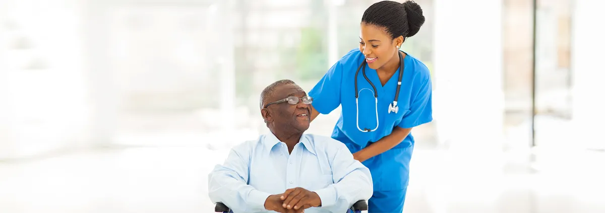 Clinician taking care of senior patient in wheelchair