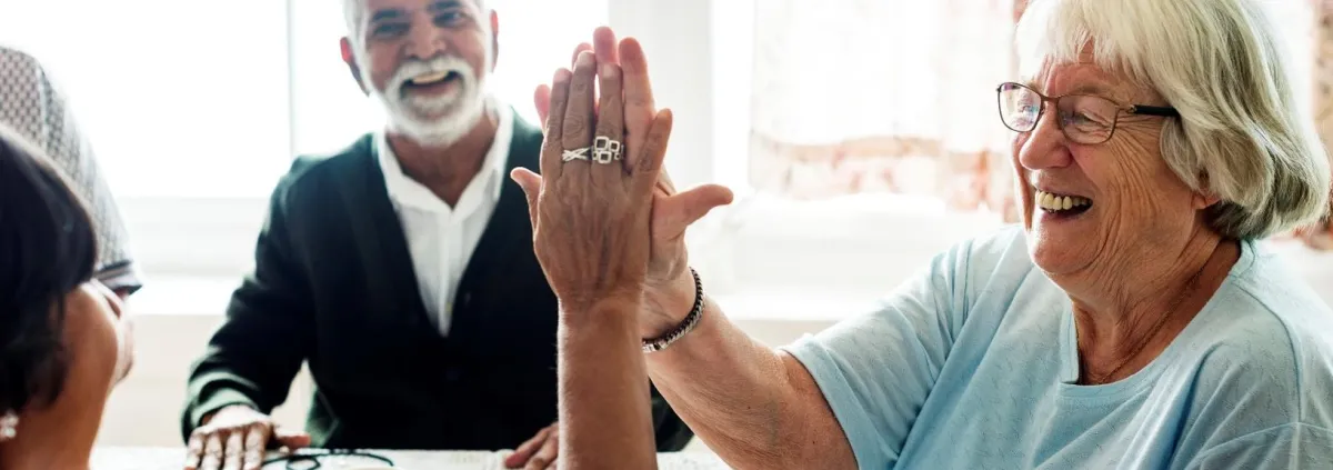 Older adults giving each other high fives