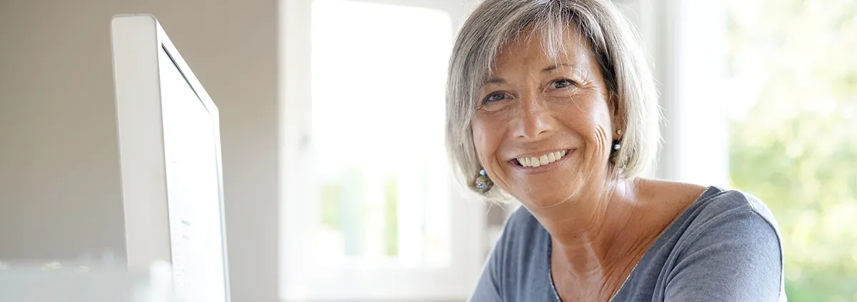 Portrait of mature businesswoman working on desktop