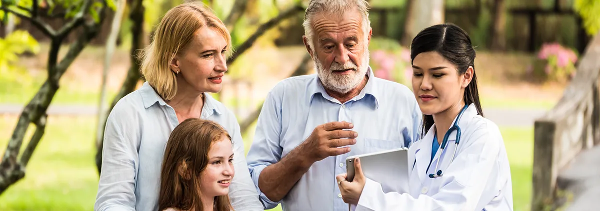 Doctor with family patients talking about medical consultation in a park. Healthcare concept