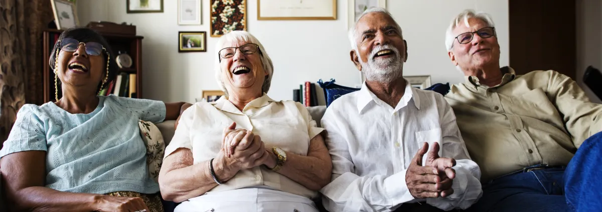 Group of senior friends sitting and watching tv together