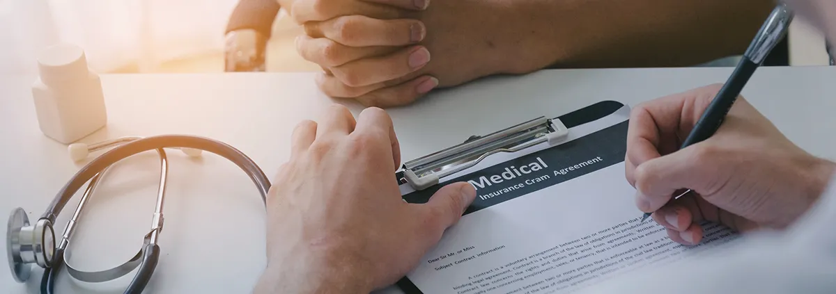 young male doctor or pharmacist writing prescription on clipboard