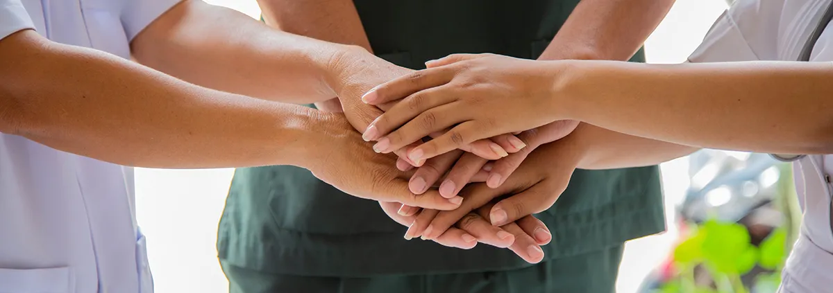 Doctors and nurses coordinate hands. Concept Teamwork in hospital for success work and trust in team