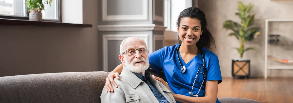 Clinician sitting with elderly patient