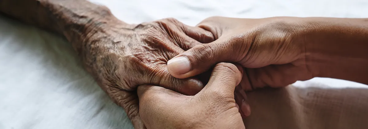 Image of 2 people holding hands