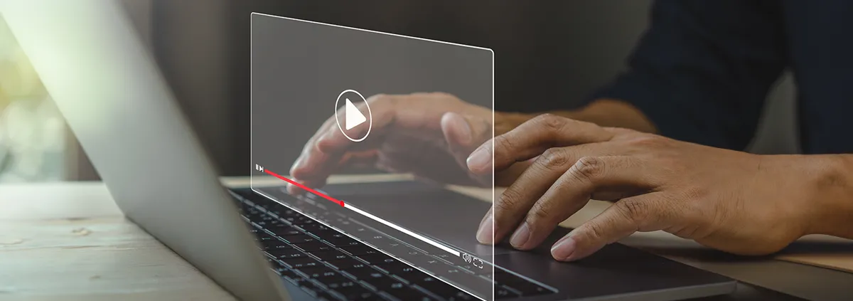 African American male watching video on laptop with play button on the screen