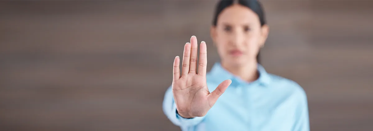 Woman holding up her hand in a stop motion