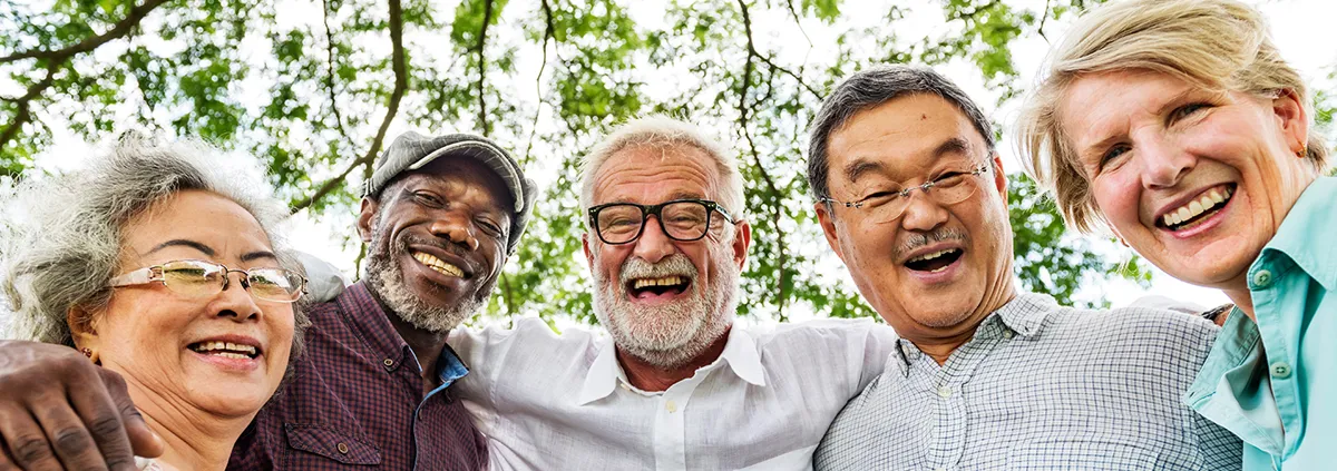 Image of culturally diverse seniors smiley at camera.