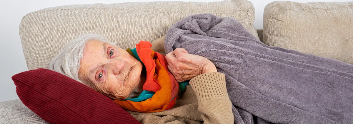 Elderly person laying on couch