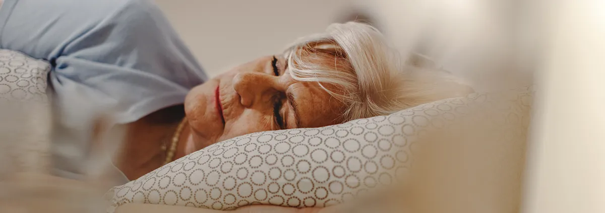 Elderly person sleeping in bed