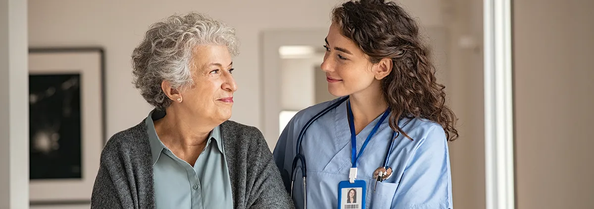 Female healthcare worker providing compassion to a senior female woman.