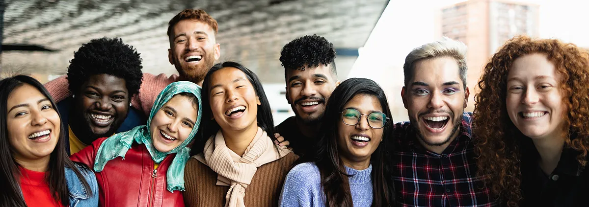 Young multi ethnic friends having fun together hanging out in the city 