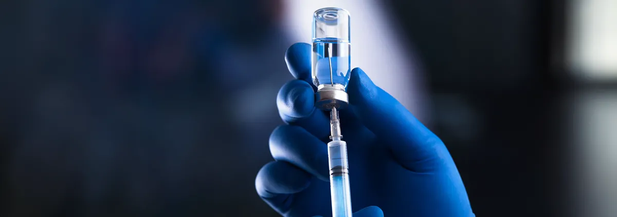 Image of syringe inside a vaccine bottle