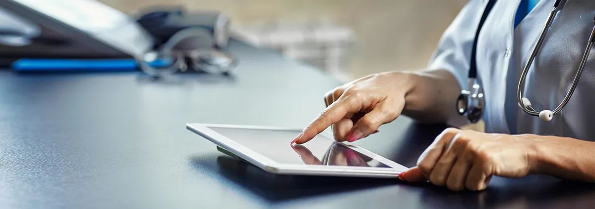 Clinician working on a digital tablet 