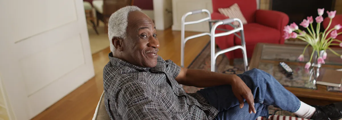 Elderly man sitting and smiling