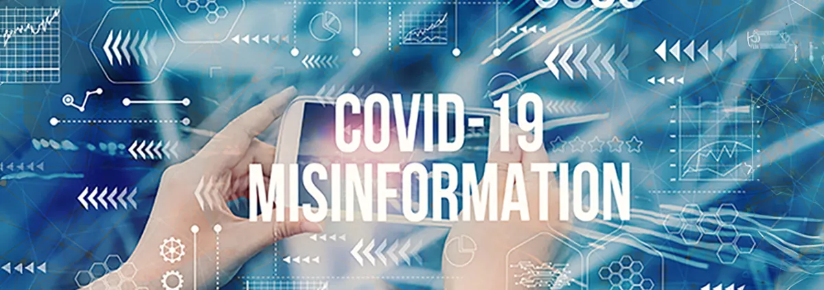 person holding digital display that says 'COVID-19 misinformation'
