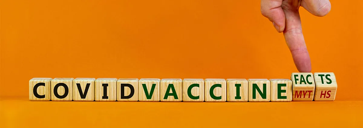 Hand turns cubes and changes words 'covid vaccine myths' to 'covid vaccine facts'