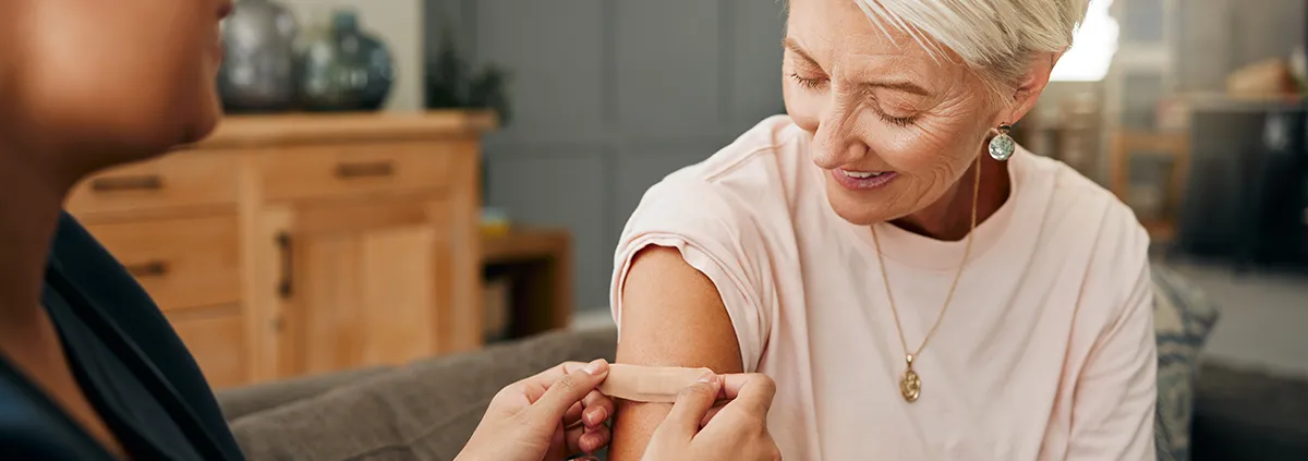 Person getting a bandaid put on by clinician