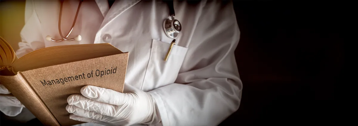 Medical professional holding book titled, "Management of Opioid"