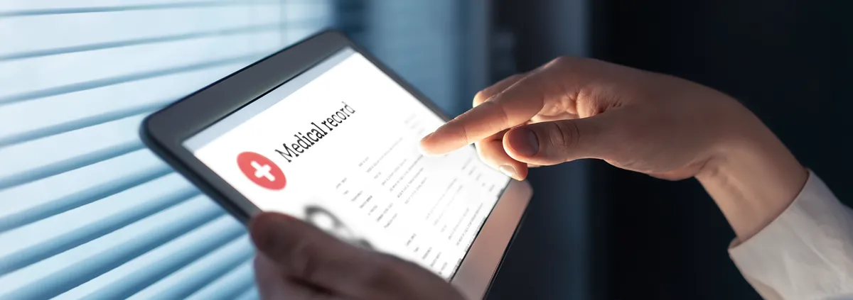 Medical professional holding iPad with medical records