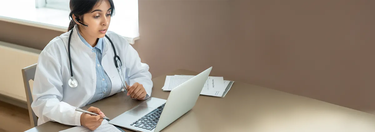 Medical professional sitting at desk on a telehealth visit