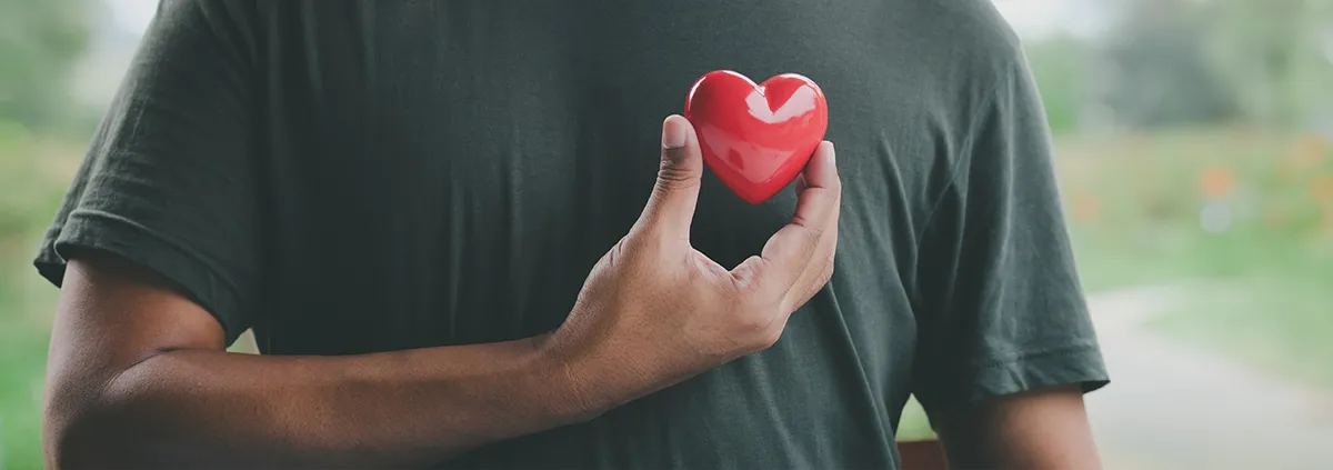 Hand holding red heart