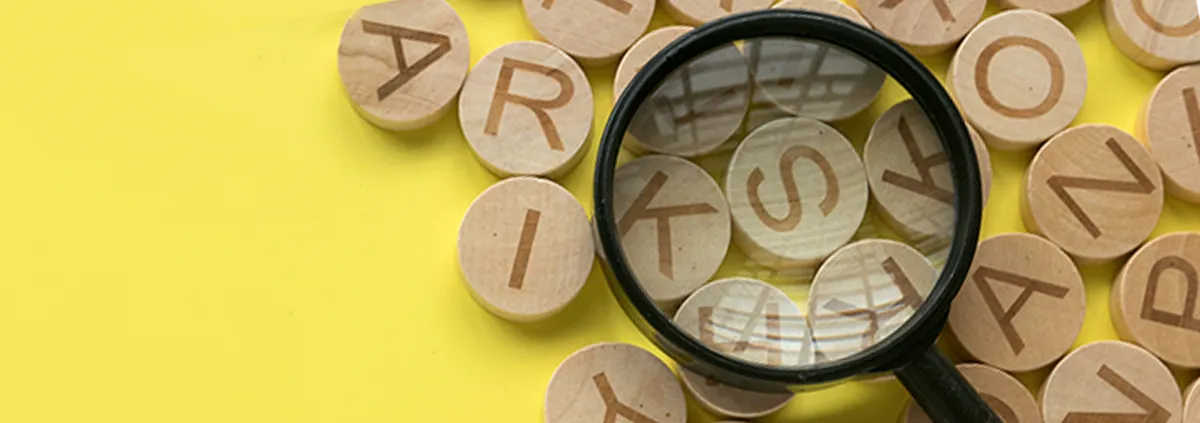 English alphabet letter and magnifying glass on yellow background