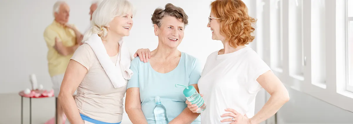 Three older women chatting after an exercise class