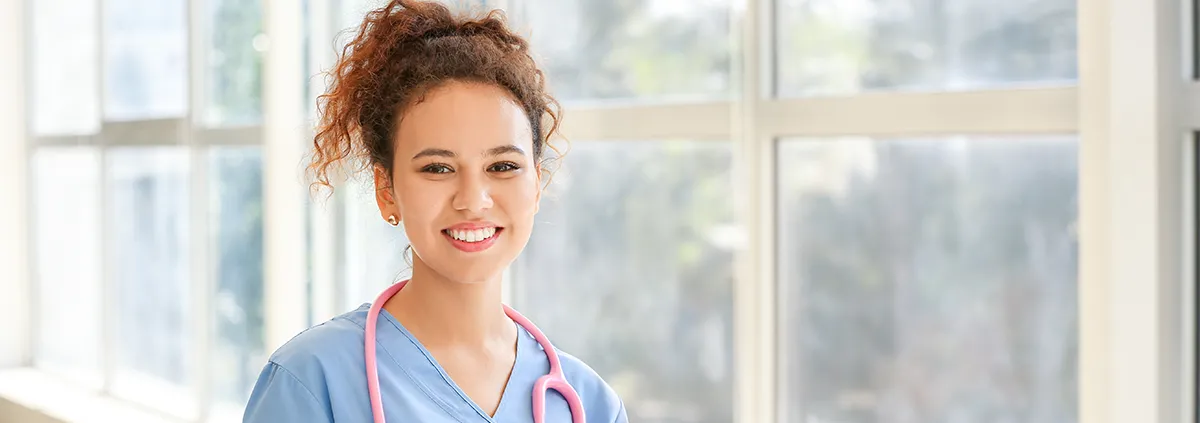 Image of female clinician holding a chart